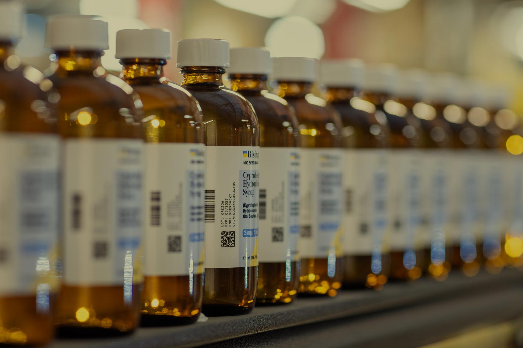 Pharmaceutical bottles lined up on shelf