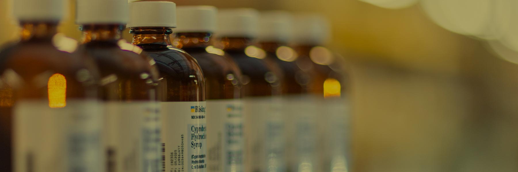 Pharmaceutical bottles lined up on shelf