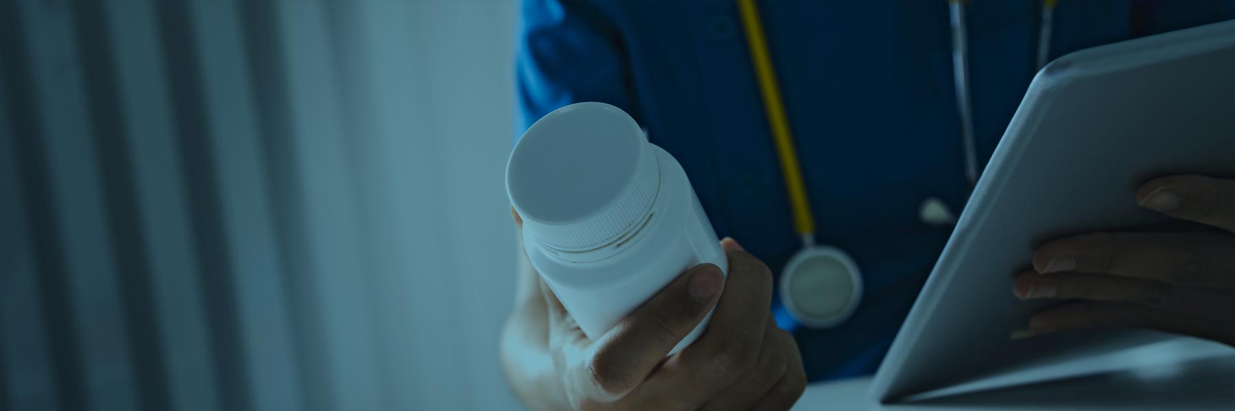 Pharmacist reading bottle of generic drugs