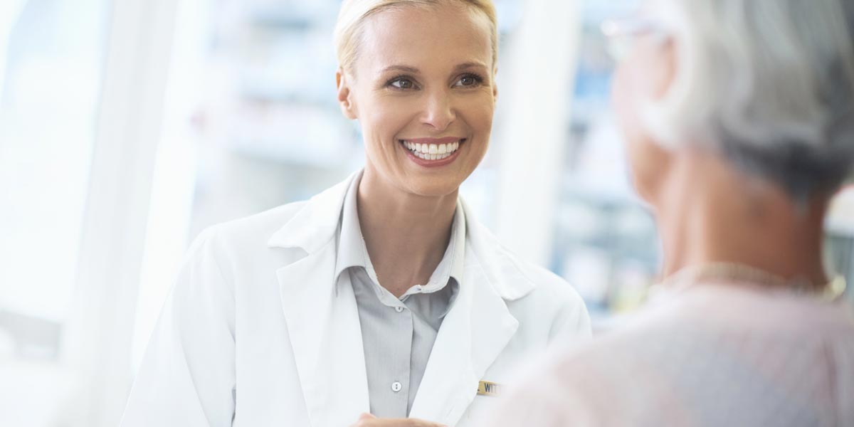 Pharmacist talking to customer